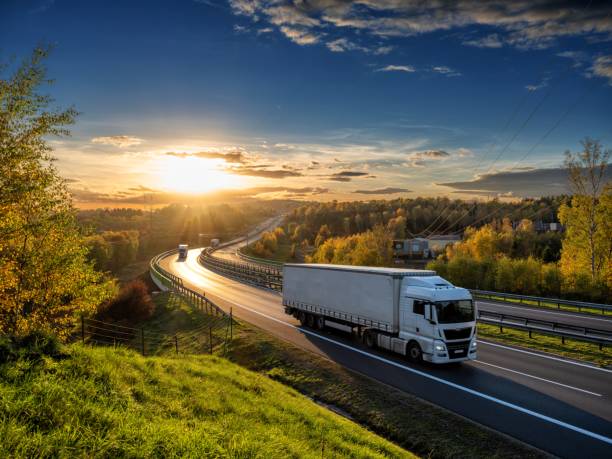 Delivery truck on highway at sunset