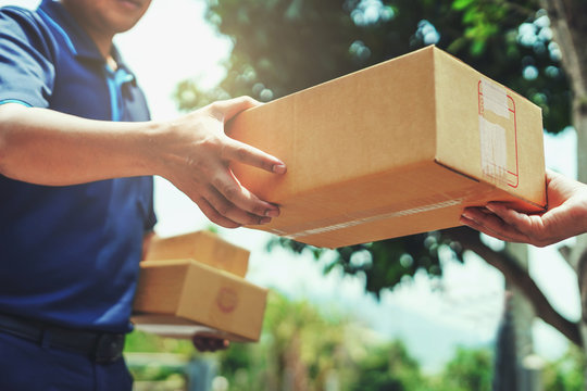 Courier handing a package to a customer
