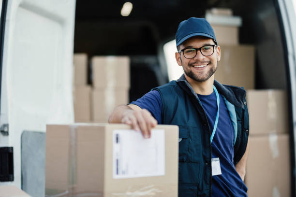 Smiling delivery driver with parcels
